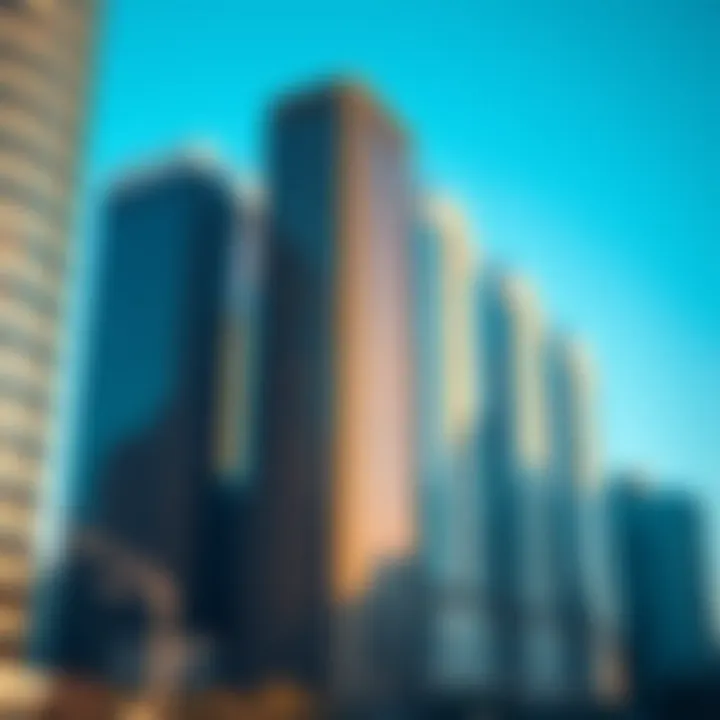 A modern urban skyline showing high-rise buildings with reflective glass windows under a clear blue sky